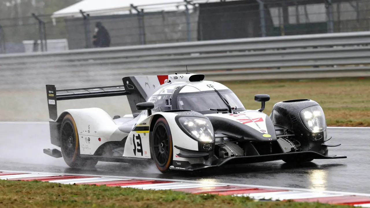 Hybrid endurance prototype cornering on a wet Silverstone track
